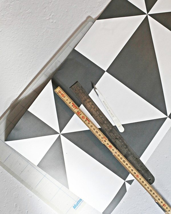 A steel rule laid across one riser's grey and white triangle panel