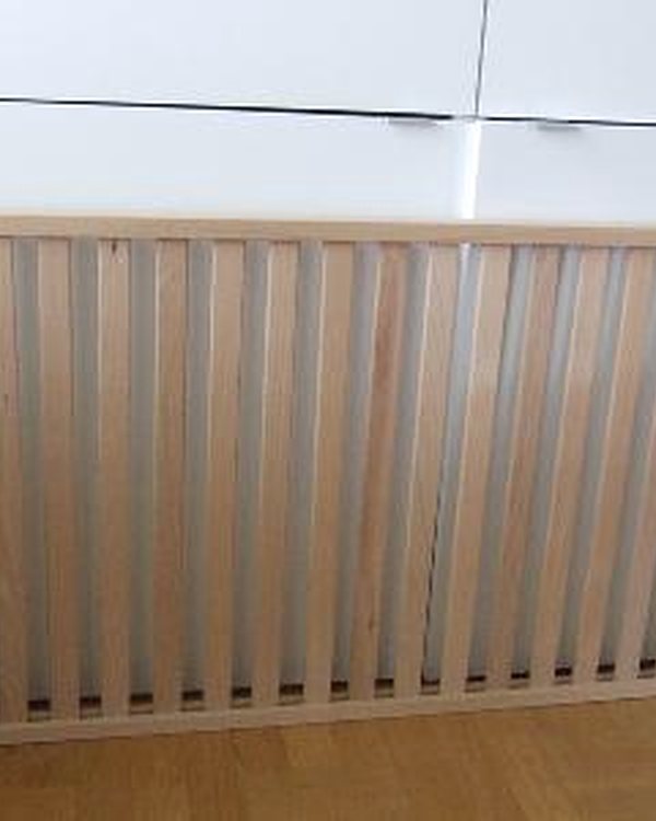 The slatted base stood on its side against a white cupboard