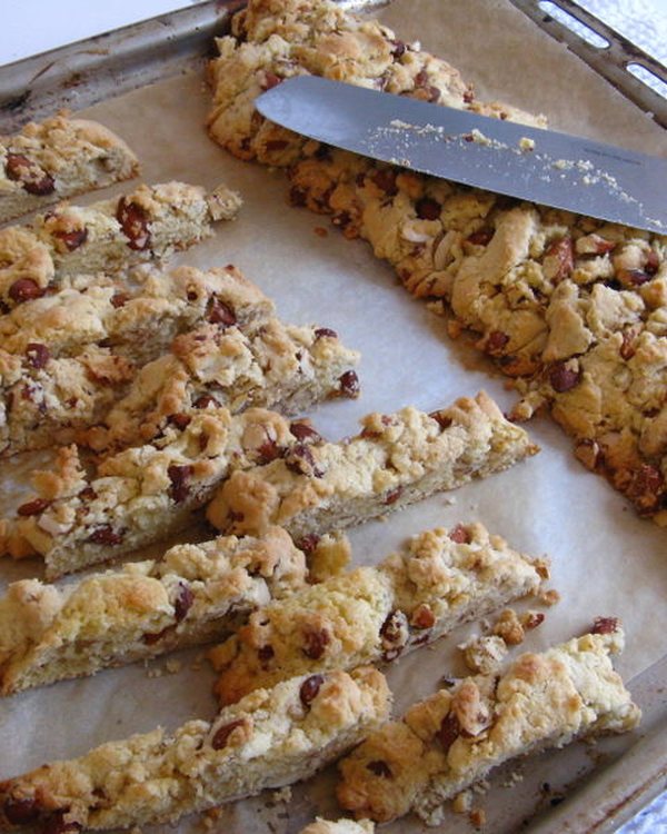 Baked loaves cut into slices and spread out on the baking sheet