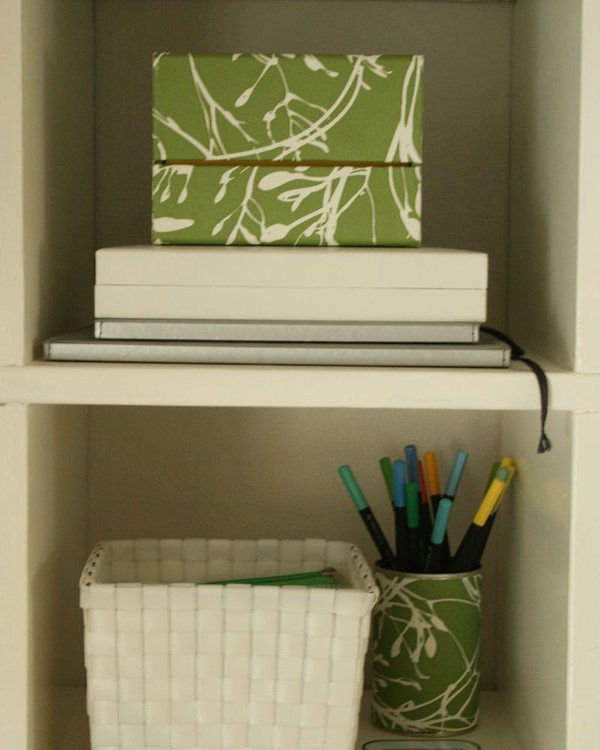 The finished green covered box on a shelf beside books and a basket