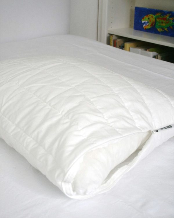 The pillow with its washable pad half fitted