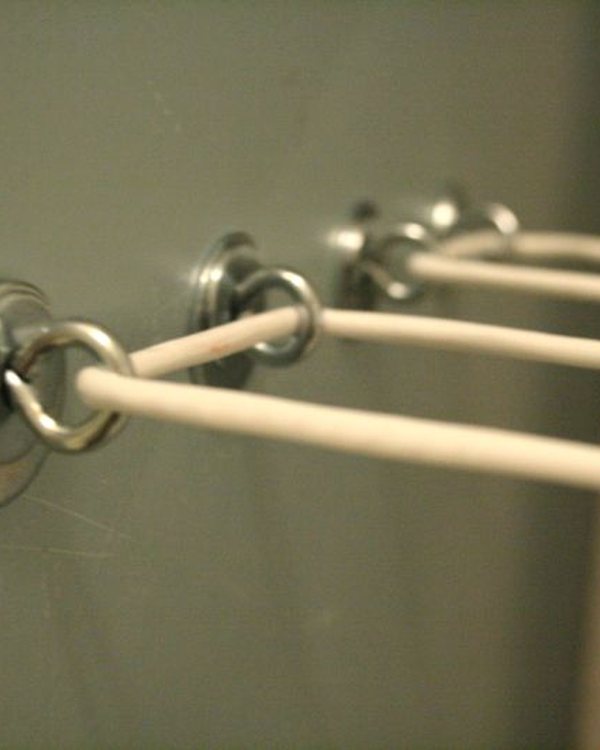 The painted batten on the wall with the line threaded through its eye hooks