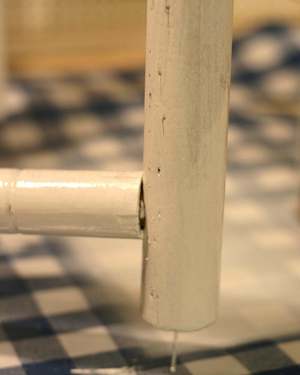 A nail driven into the underside of a turned leg so the piece stands clear of the wet paint