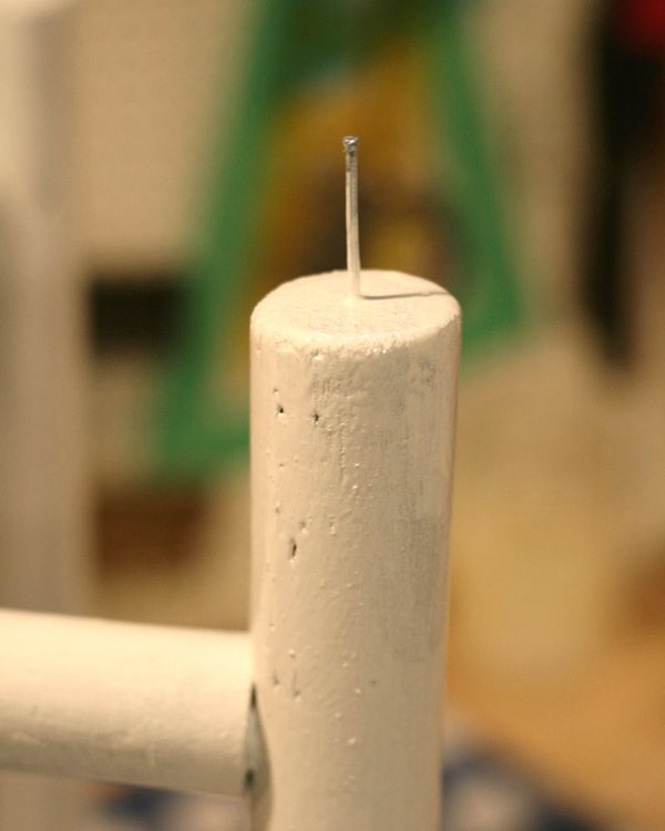 Close up of the nail head acting as a foot under the painted leg