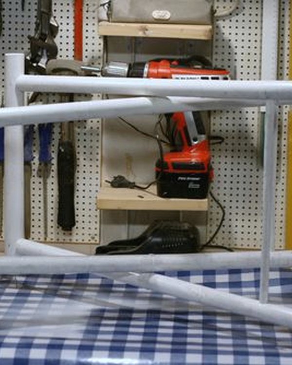 A folding frame standing on nails while its second coat dries