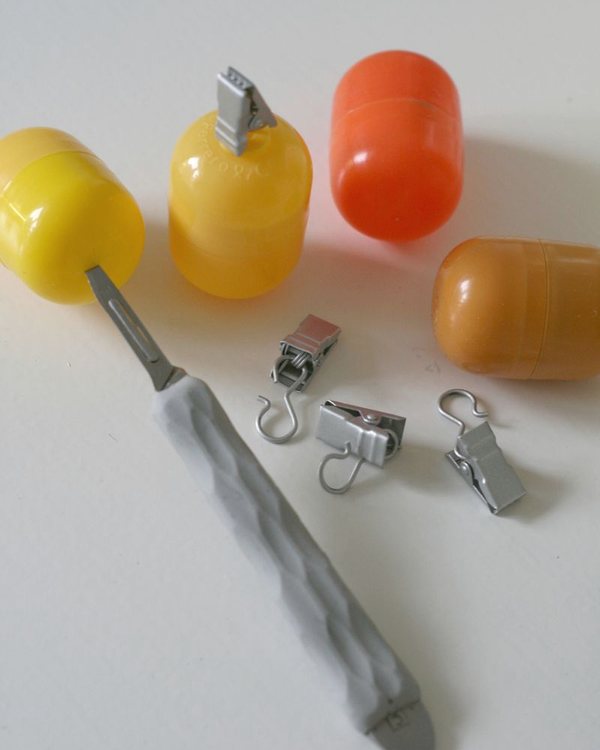 Plastic egg capsules, curtain clips and a trowel of wet concrete