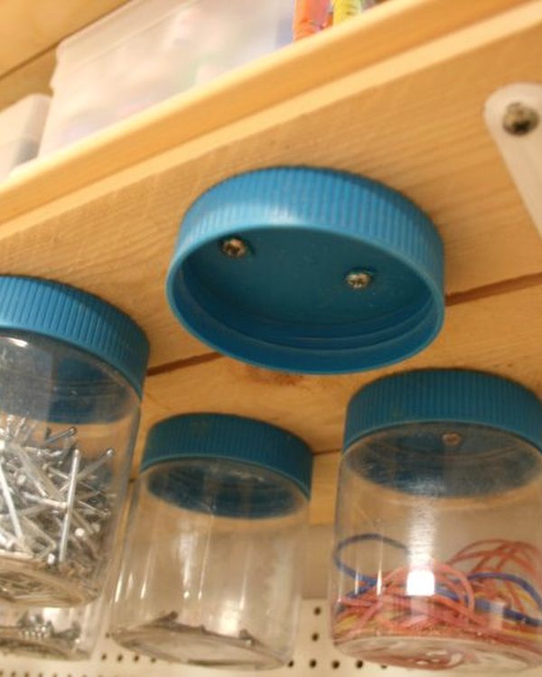 Looking up at the mounted lids with jars twisted onto them
