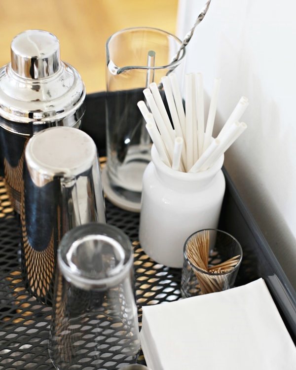 Shaker, strainer and stirrers in a jar on the trolley