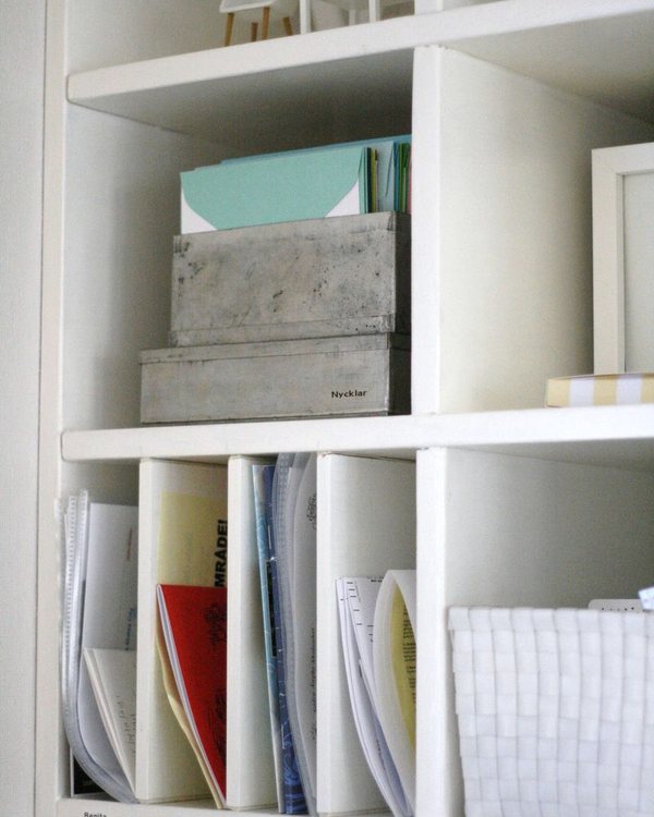 Shelves of folders and magazine files above the desk