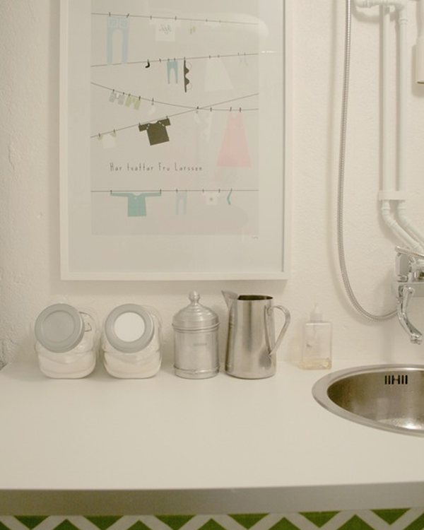 The sink set into the worktop, jugs and bottles alongside